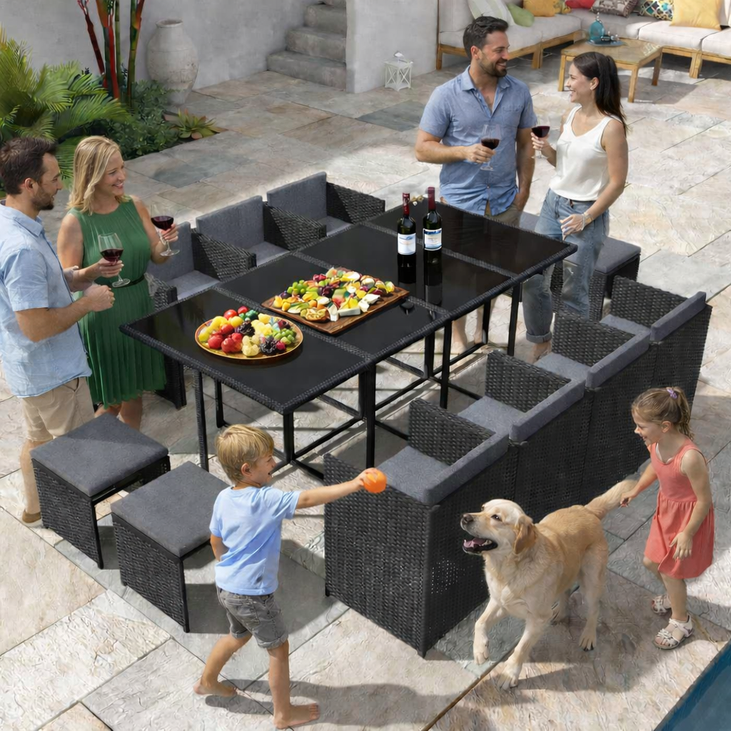 Outdoor furniture with family and a dog enjoying food on a patio.
