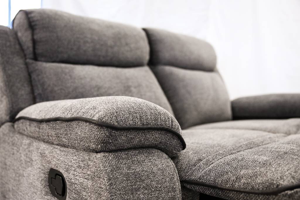 Gray fabric sofa with recliner feature in a room setting